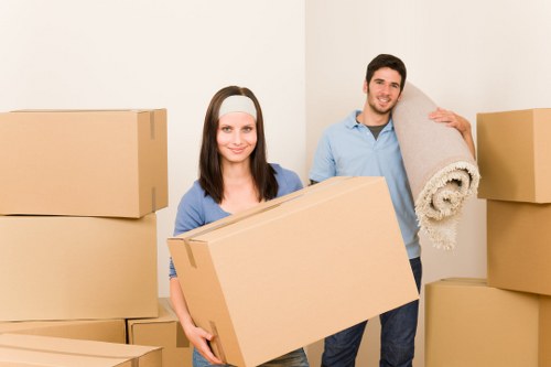 Movers carrying furniture through a residential property in Riddlesdown