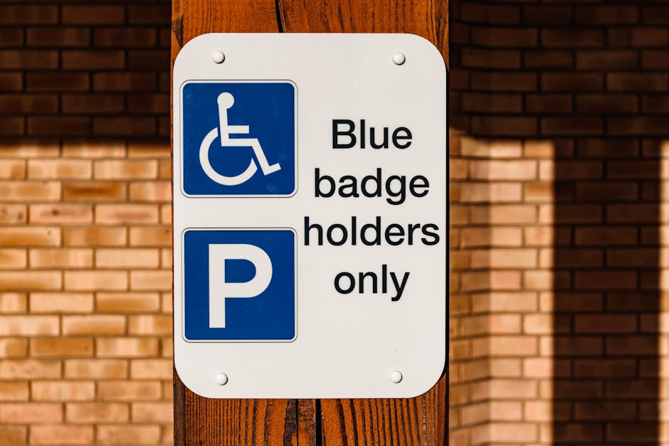 Close-up of a green and white municipal parking sign mounted on a metal pole in an outdoor setting. The sign indicates a two-hour parking limit from 8 am to 8 pm, Monday through Saturday, with an exception for Sundays. The background features a bright blue sky with scattered white clouds and areas of greenery, including trees with lush foliage. The sign is positioned in a residential or urban area, likely near a property involved in house removals or moving services, as suggested by the context from manwithvanriddlesdown.co.uk. The image captures the sign during daytime with natural lighting, emphasizing clear visibility and readability of the parking regulations, relevant for planning logistical aspects of home relocation or furniture transport in Riddlesdown, Croydon.